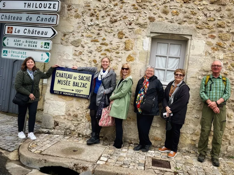 Chateau de Saché sign with intermediate group of Immersion Workshop attendees